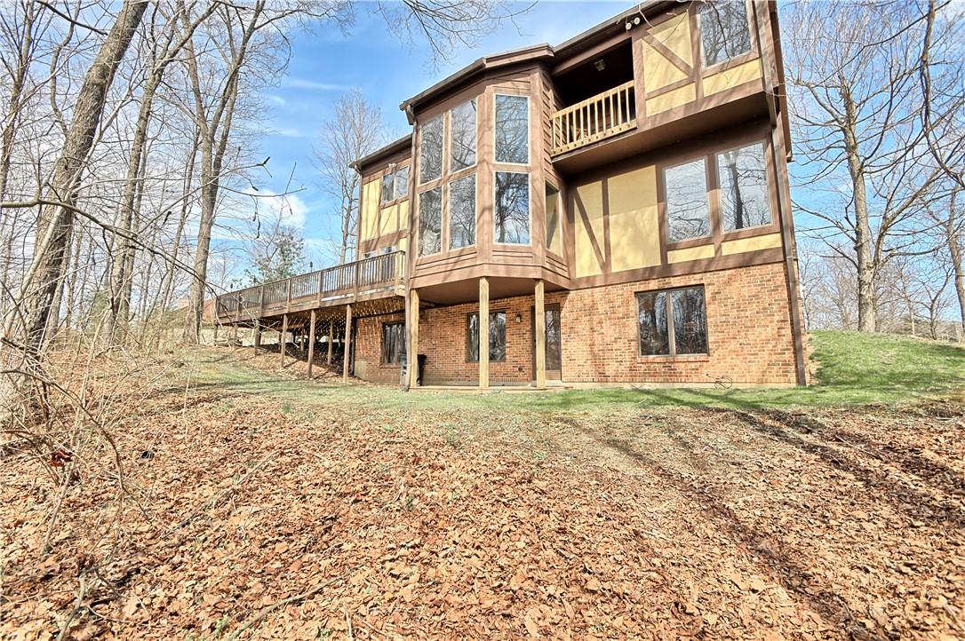 8711 Nicole Lane Springboro, OH 45066 - Photo 82 of 87 This home features a spacious deck and large windows, perfect for enjoying the surrounding natural beauty.
