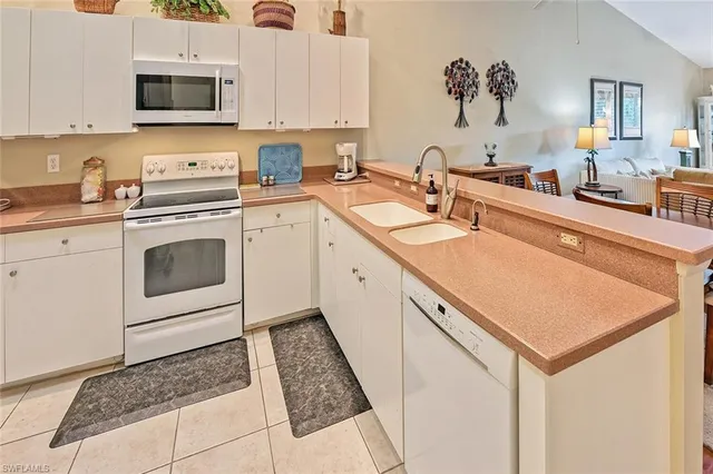 a kitchen with a sink stove and microwave
