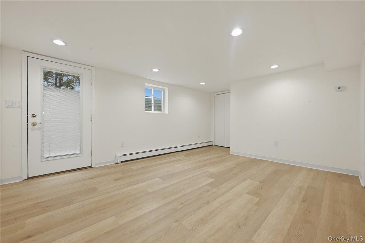 84 North Fordham Road Hicksville, NY 11801 - Photo 19 of 28 an empty room with wooden floor and windows