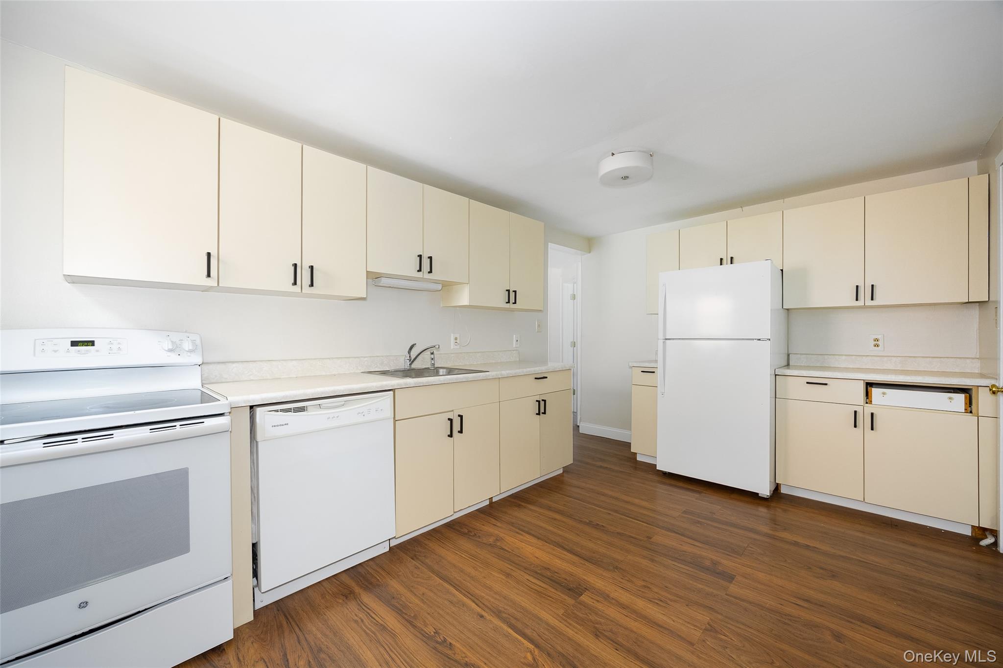 29 Delano Street, Unit 2 Poughkeepsie, NY 12601 - Photo 3 of 16 a kitchen with cabinets appliances wooden floor and a window
