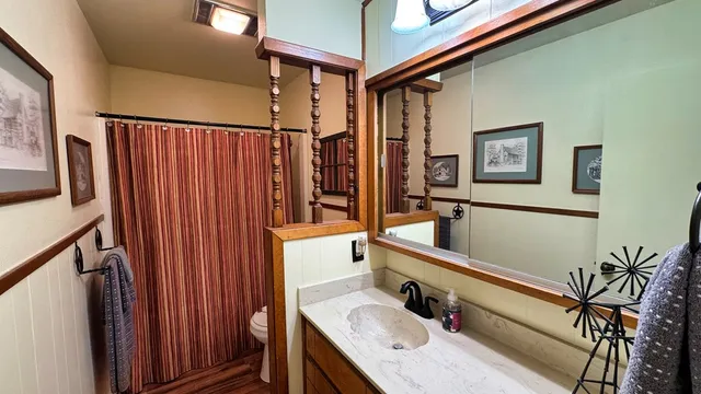 a bathroom with shower a sink and a mirror