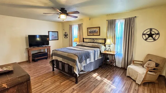 a bedroom with a bed and a flat screen tv