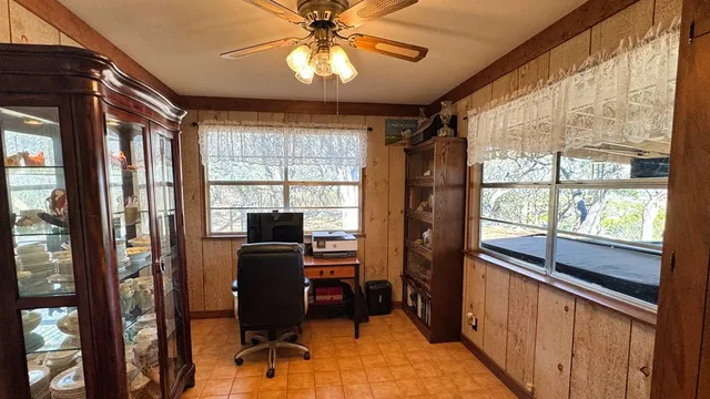 a view of a workspace with furniture and a window