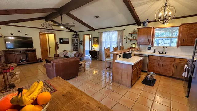 a living room with furniture a flat screen tv and a window