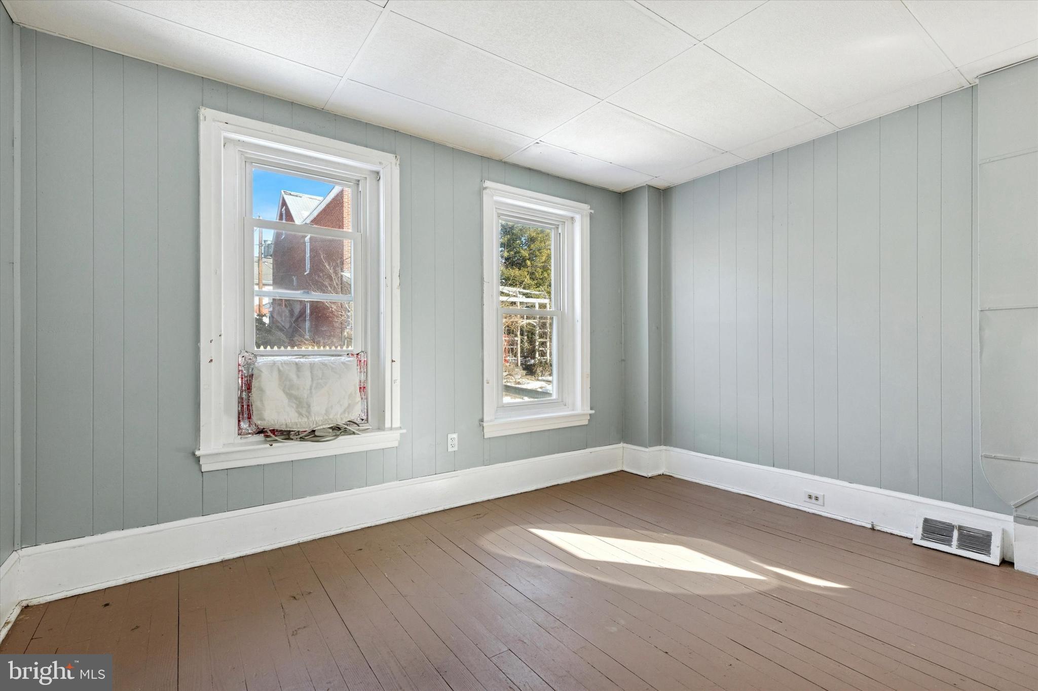 24 East 5th Street Pottstown, PA 19464 - Photo 4 of 15 an empty room with wooden floor and windows