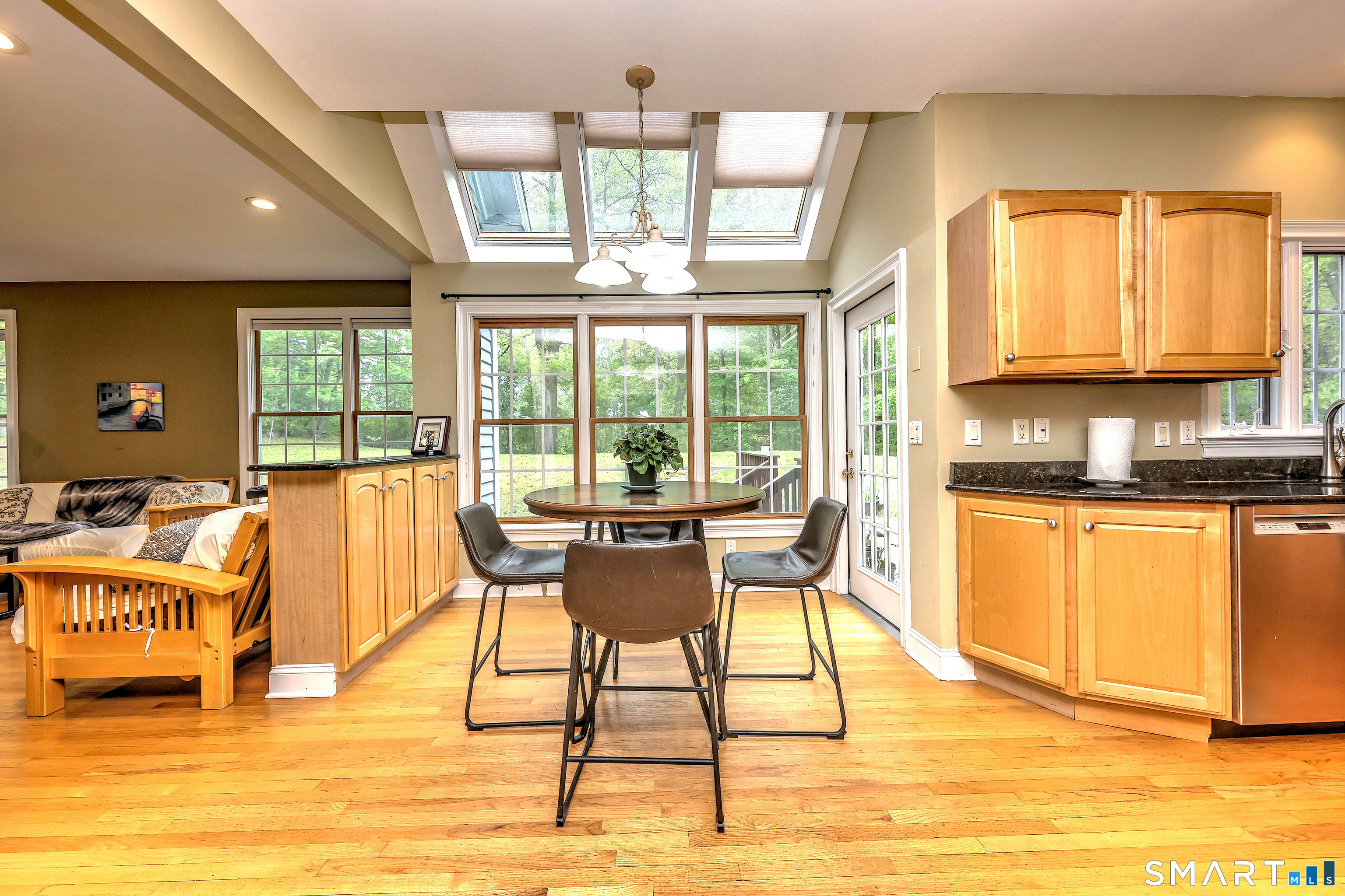 125 Peck Hill Road Woodbridge, CT 06525 - Photo 12 of 40 a dining room with wooden floor and large window