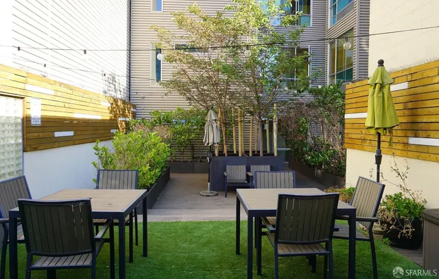 a view of a patio with table and chairs and potted plants