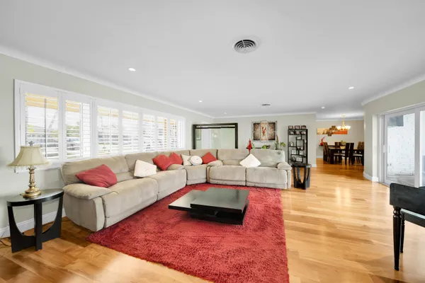 a living room with furniture and wooden floor
