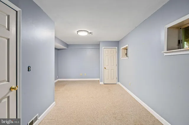 a bathroom with a toilet mirror vanity and a sink