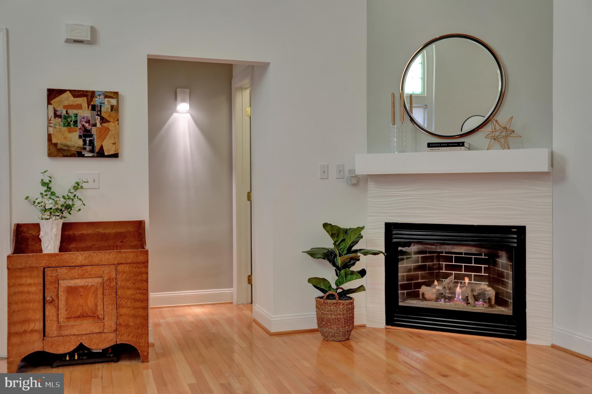 832 Trinity Street Baltimore, MD 21202 - Photo 5 of 60 Gas log fireplace, closet and powder room.