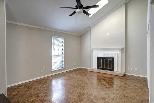 a view of empty room with fireplace and wooden floor