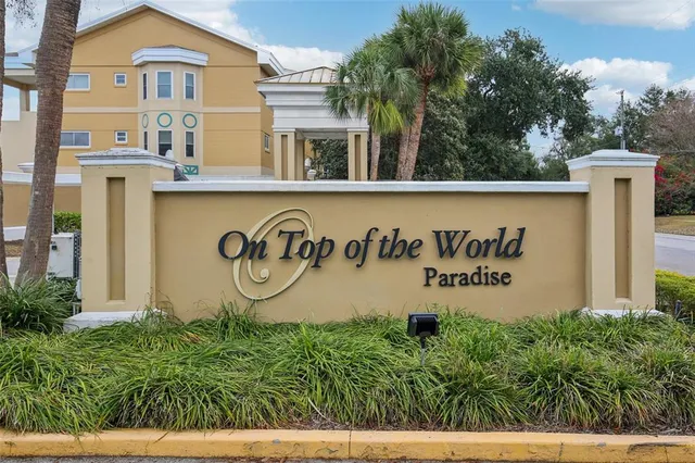 an aerial view of a house with a garden and lake view