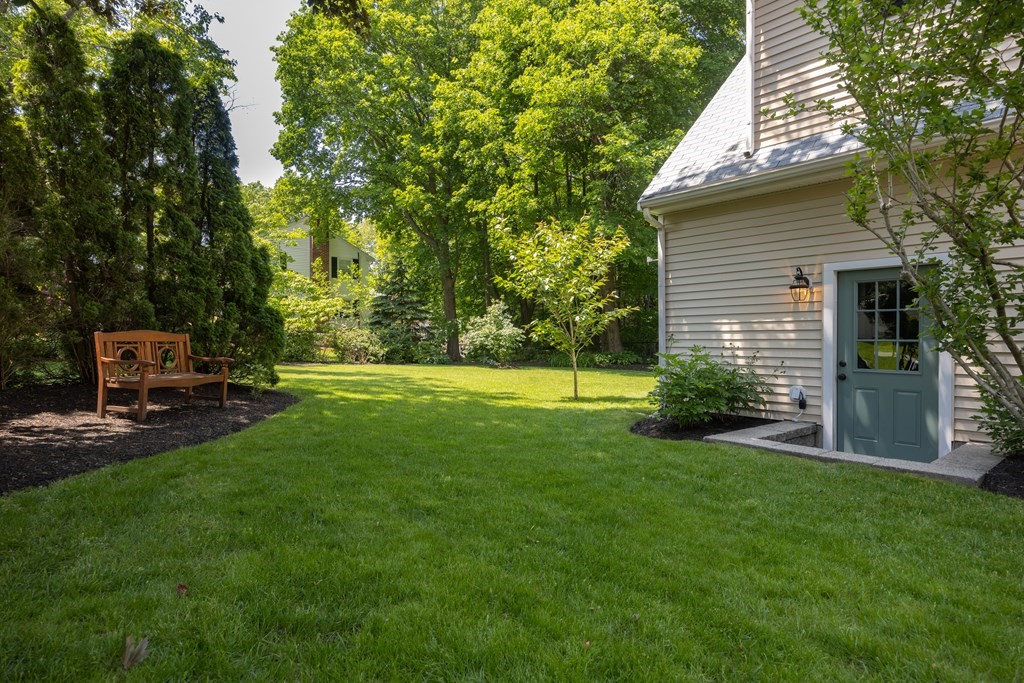 64 Reed Street Lexington, MA 02421 - Photo 12 of 12 a view of a house with backyard and a tree