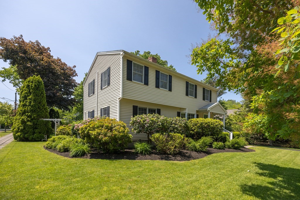 64 Reed Street Lexington, MA 02421 - Photo 6 of 12 a front view of a house with a garden