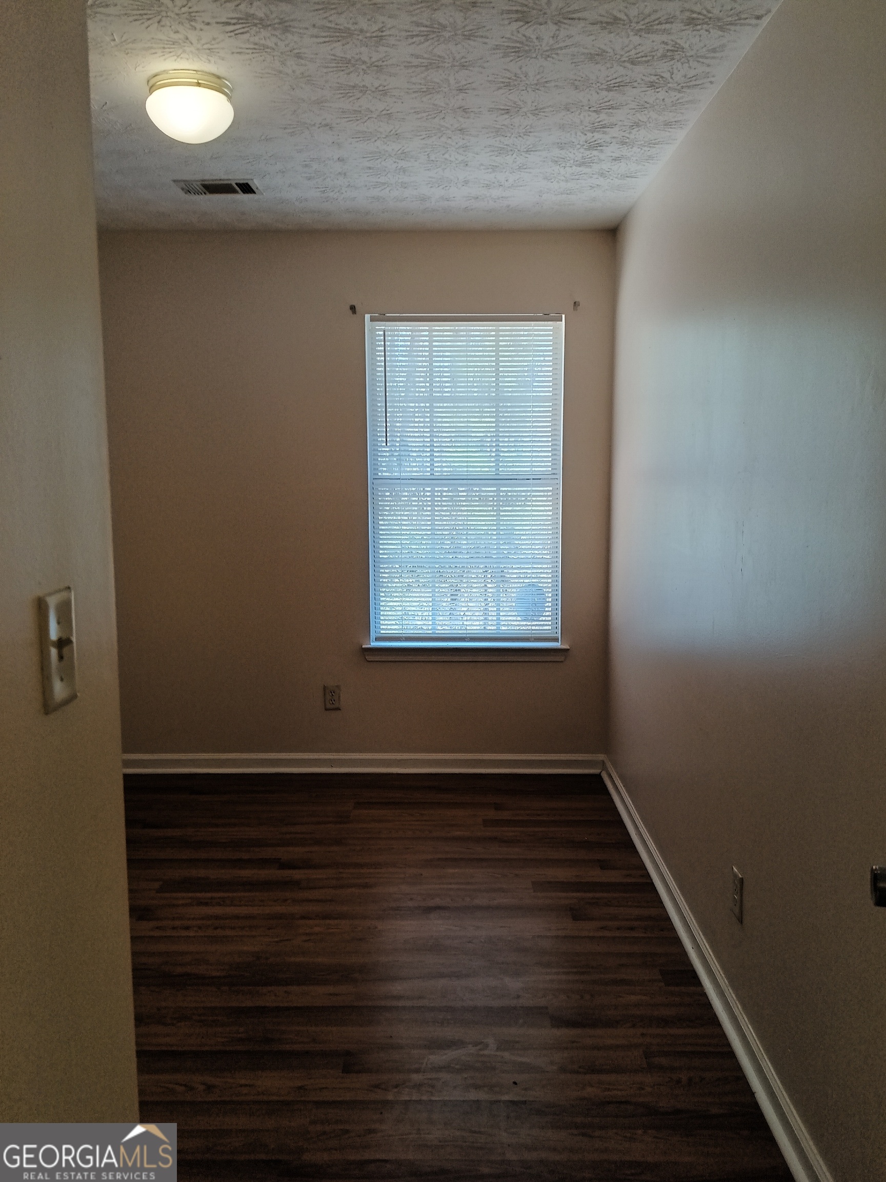 3049 Fields Drive Lithonia, GA 30038 - Photo 11 of 14 an empty room with wooden floor and windows