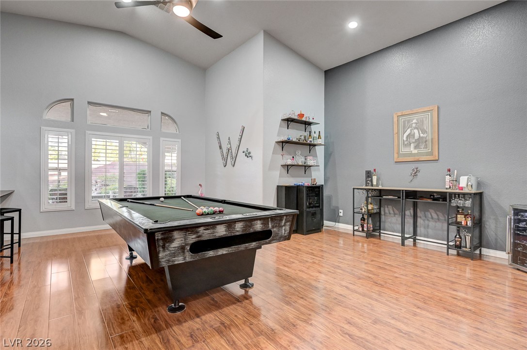 1604 Cattle Ranch Place Henderson, NV 89002 - Photo 14 of 99 Entertaining haven with soaring vaulted ceilings and polished hardwood flooring, ideal for recreation.