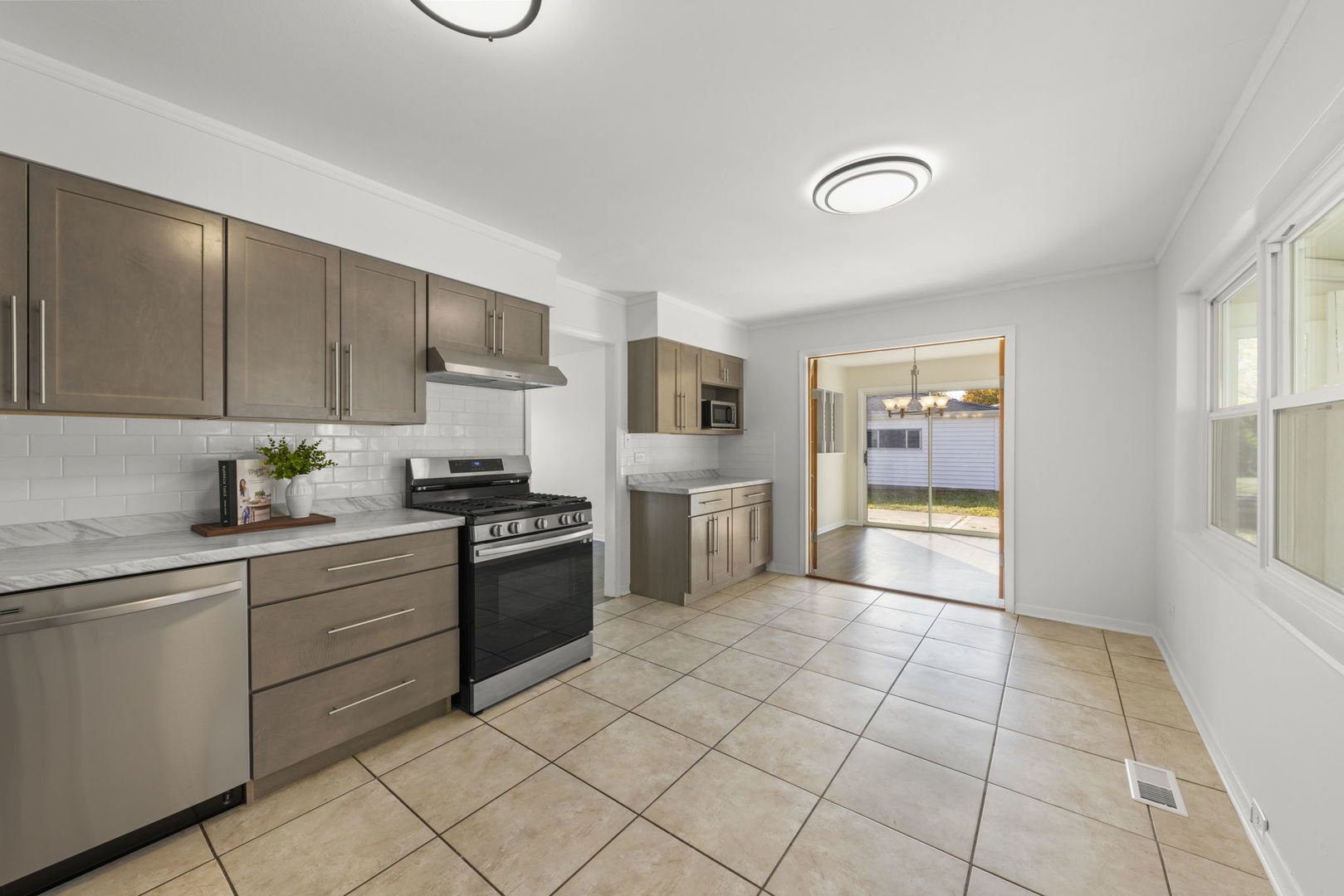 90 Pleasant Street Hoffman Estates, IL 60169 - Photo 11 of 43 a kitchen with white cabinets a sink and appliances