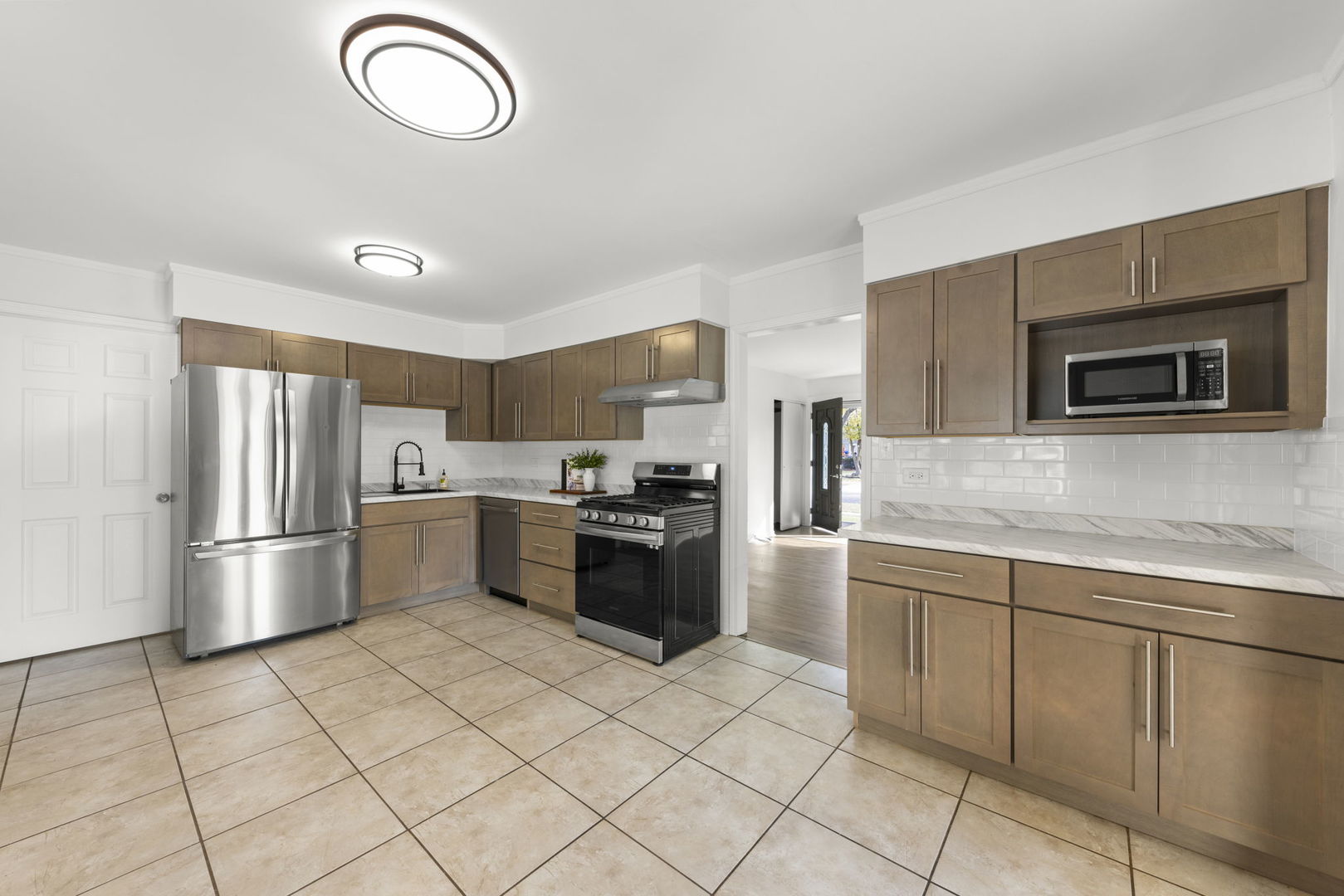 90 Pleasant Street Hoffman Estates, IL 60169 - Photo 9 of 43 a kitchen with a sink stainless steel appliances and cabinets