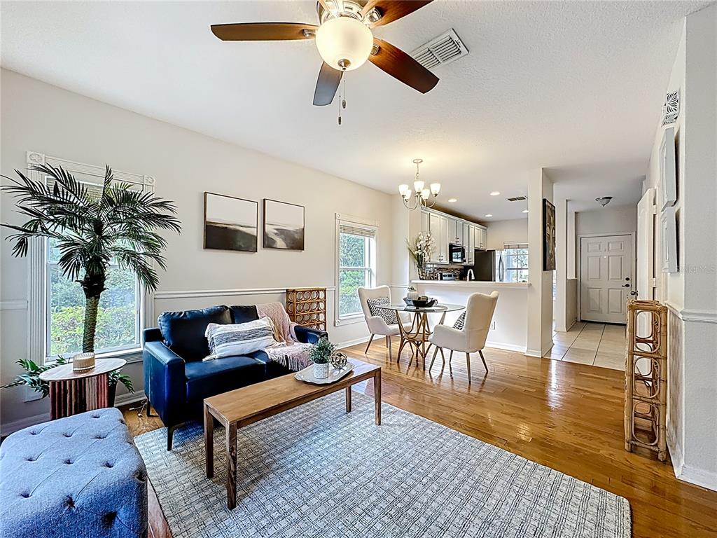 10300 Manderley Way, Unit 119 Orlando, FL 32829 - Photo 15 of 42 a living room with furniture and a chandelier