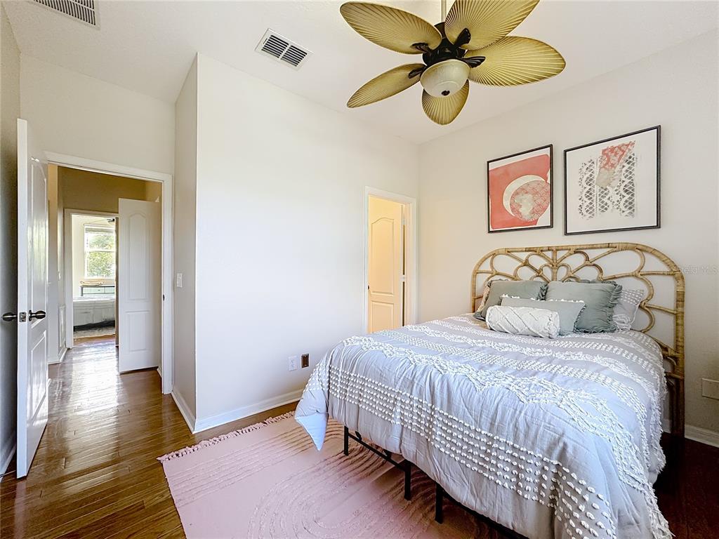 10300 Manderley Way, Unit 119 Orlando, FL 32829 - Photo 18 of 42 a bedroom with a bed and a chandelier