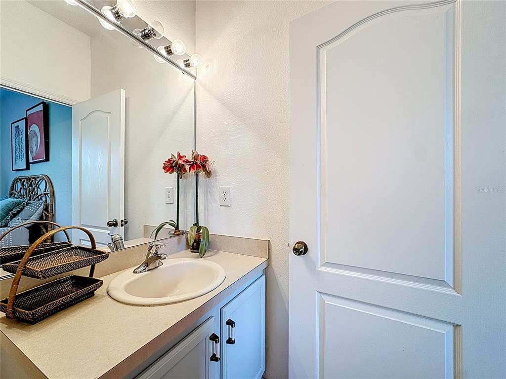 10300 Manderley Way, Unit 119 Orlando, FL 32829 - Photo 19 of 42 a bathroom with a sink and a mirror