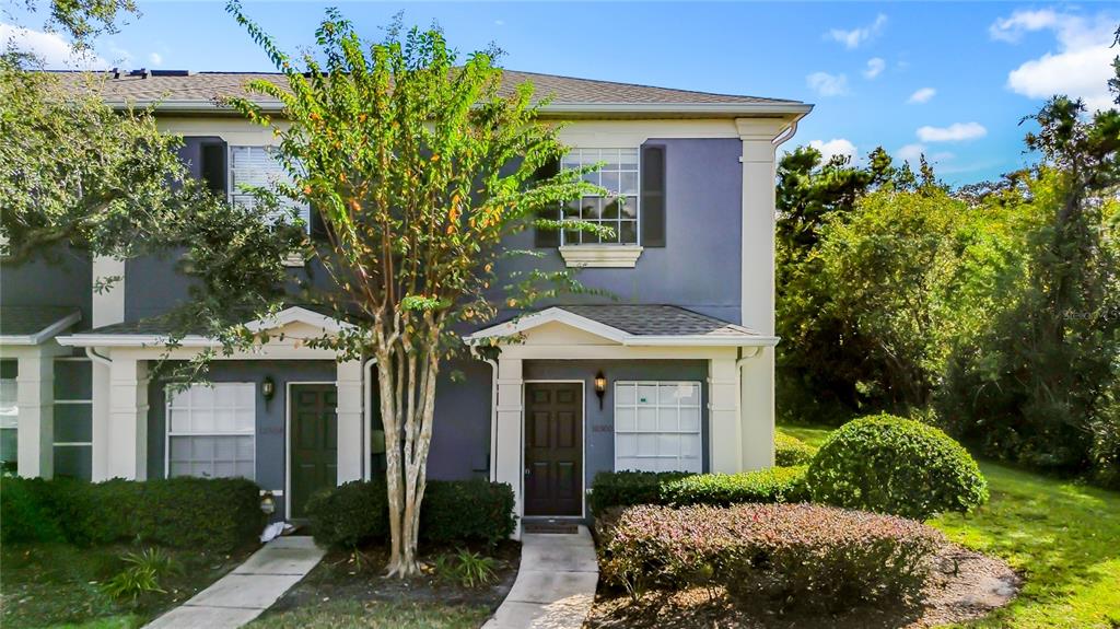 10300 Manderley Way, Unit 119 Orlando, FL 32829 - Photo 2 of 42 a front view of a house with garden