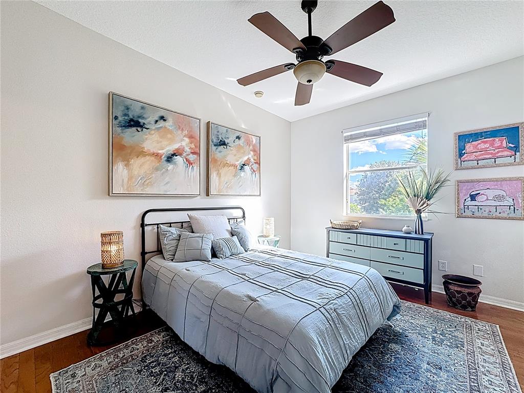 10300 Manderley Way, Unit 119 Orlando, FL 32829 - Photo 21 of 42 a bedroom with a bed and a painting on the wall