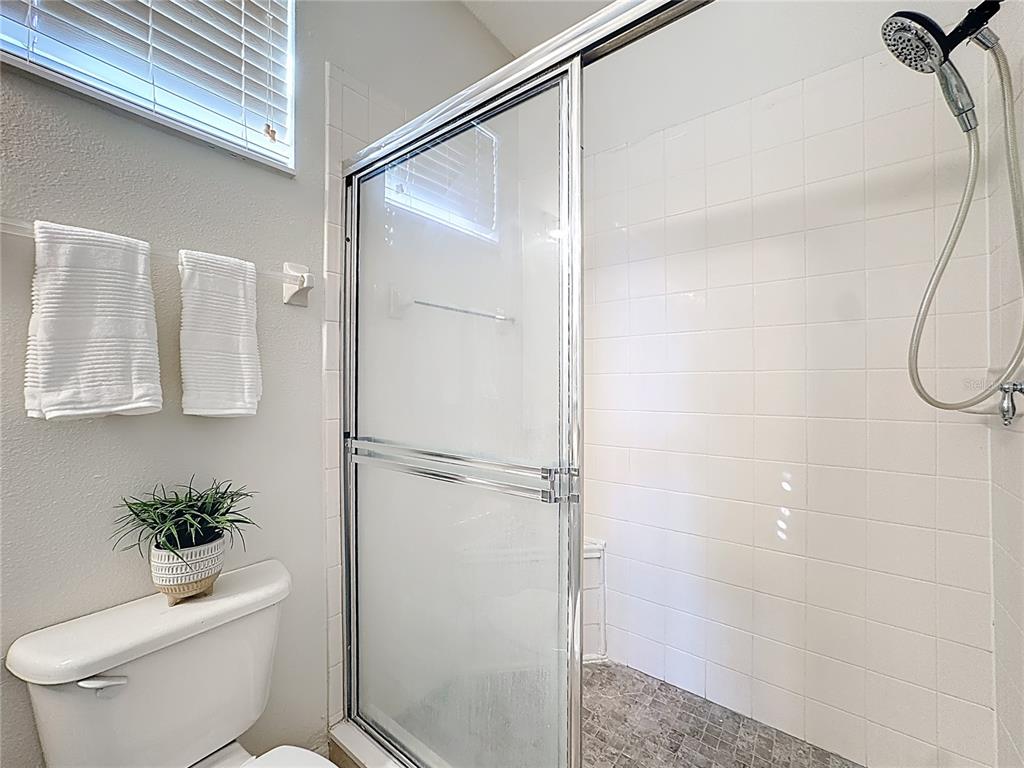 10300 Manderley Way, Unit 119 Orlando, FL 32829 - Photo 25 of 42 a bathroom with a shower a toilet and a shower