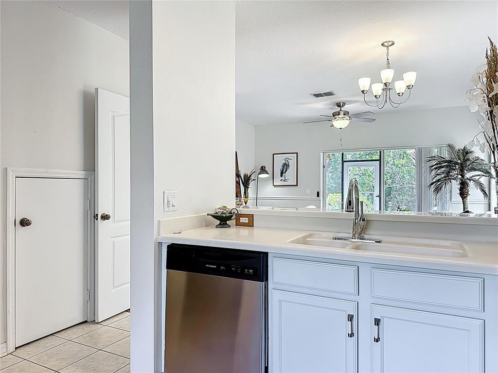 10300 Manderley Way, Unit 119 Orlando, FL 32829 - Photo 8 of 42 a kitchen with a sink and a chandelier