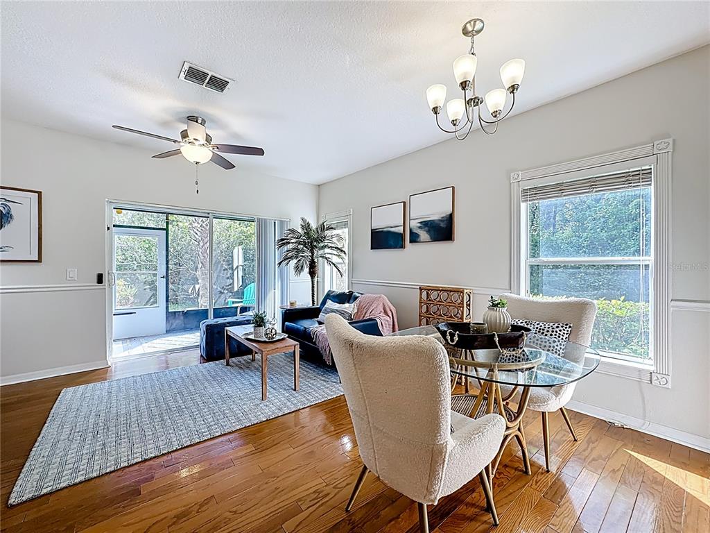 10300 Manderley Way, Unit 119 Orlando, FL 32829 - Photo 9 of 42 a living room with furniture a chandelier and a table