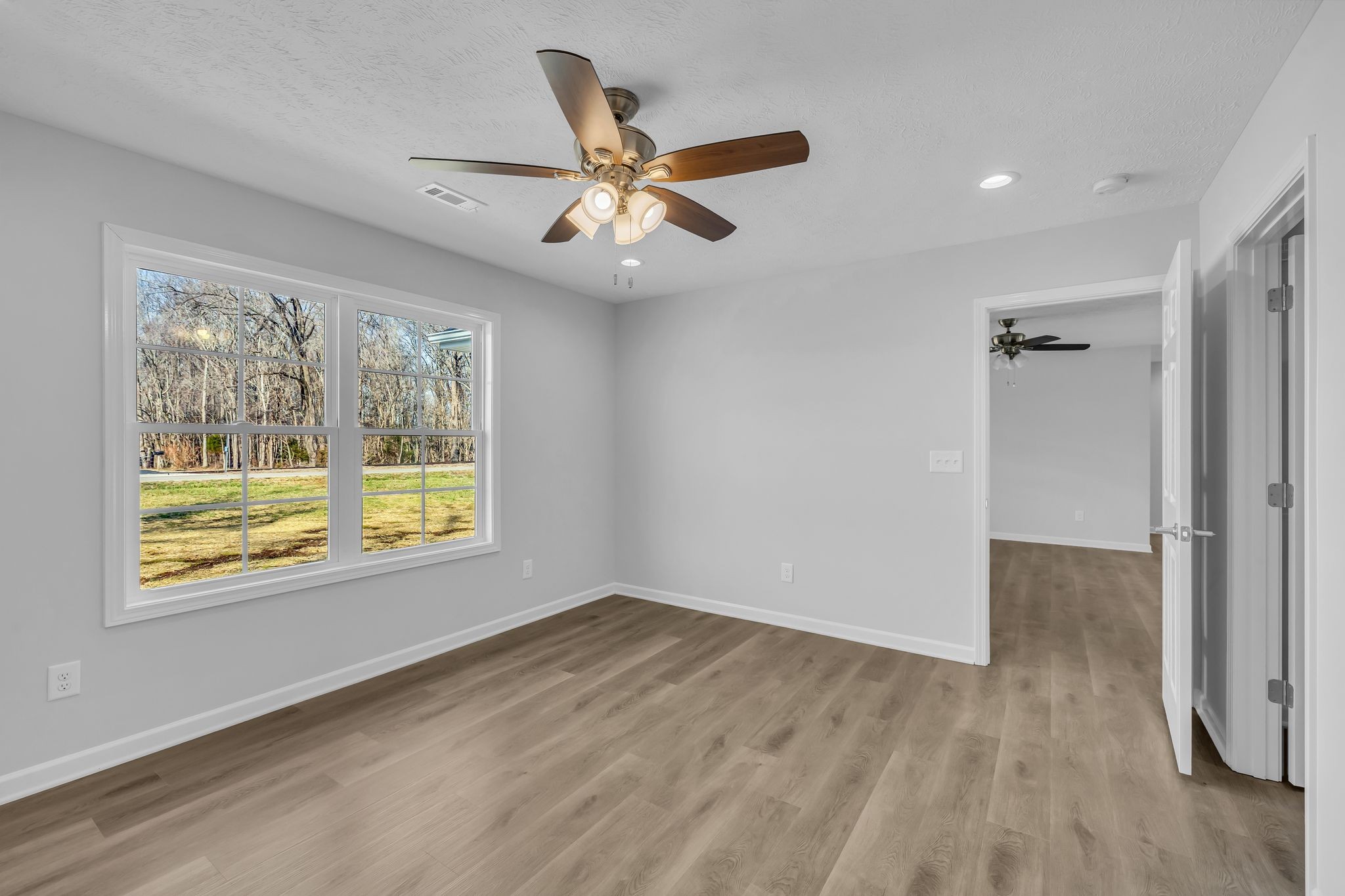 638 Summitville Road Manchester, TN 37355 - Photo 16 of 33 a view of an empty room with wooden floor and a window