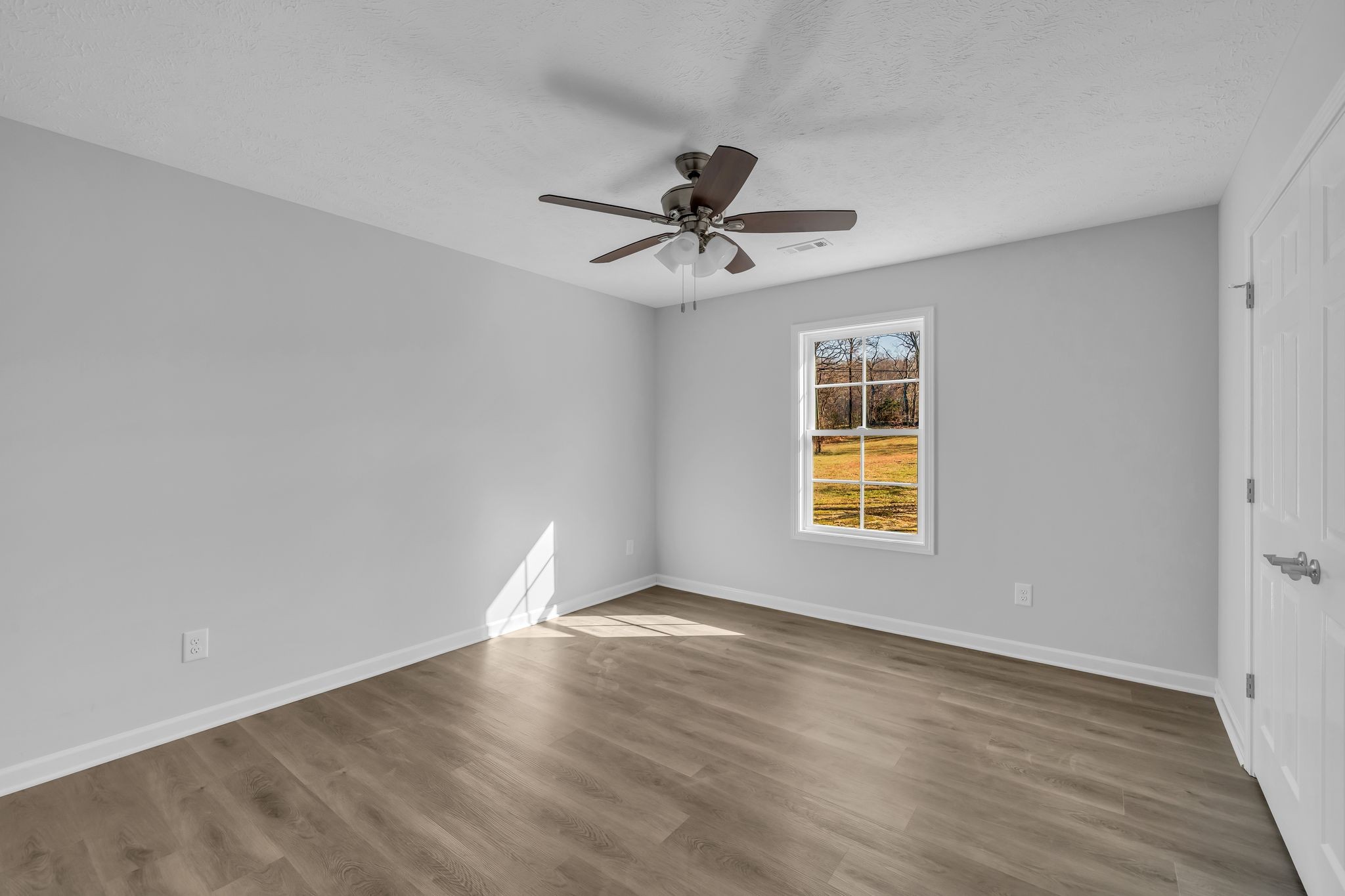 638 Summitville Road Manchester, TN 37355 - Photo 25 of 33 a view of an empty room with window and wooden floor