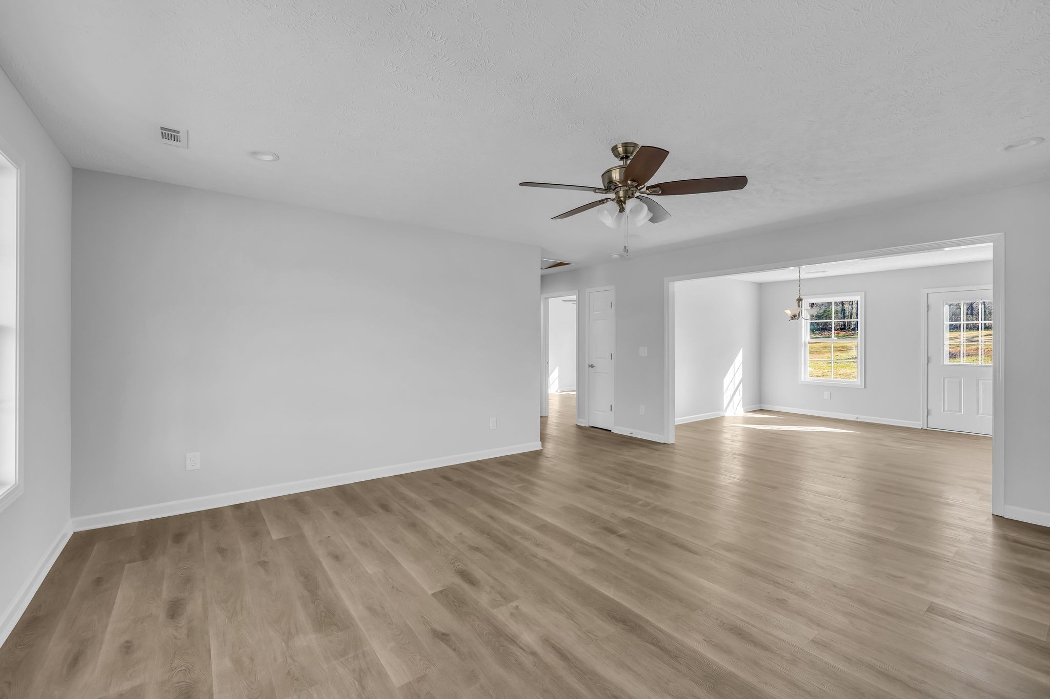 638 Summitville Road Manchester, TN 37355 - Photo 6 of 33 a view of a livingroom with a ceiling fan and wooden floor