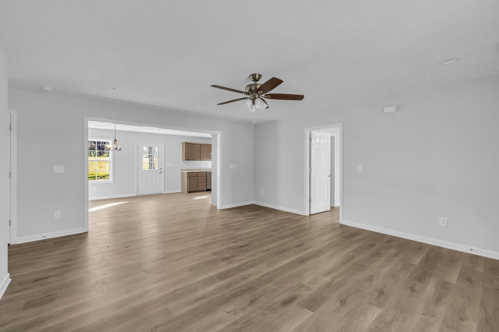 638 Summitville Road Manchester, TN 37355 - Photo 8 of 33 a view of an empty room with a window and wooden floor
