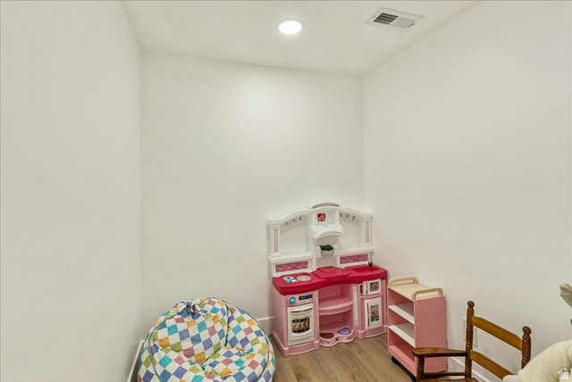 3916 South Sage Wood Avenue Mapleton, UT 84664 - Photo 23 of 33 Recessed ceiling lighting illuminates a room with light-toned walls and wood-finish flooring