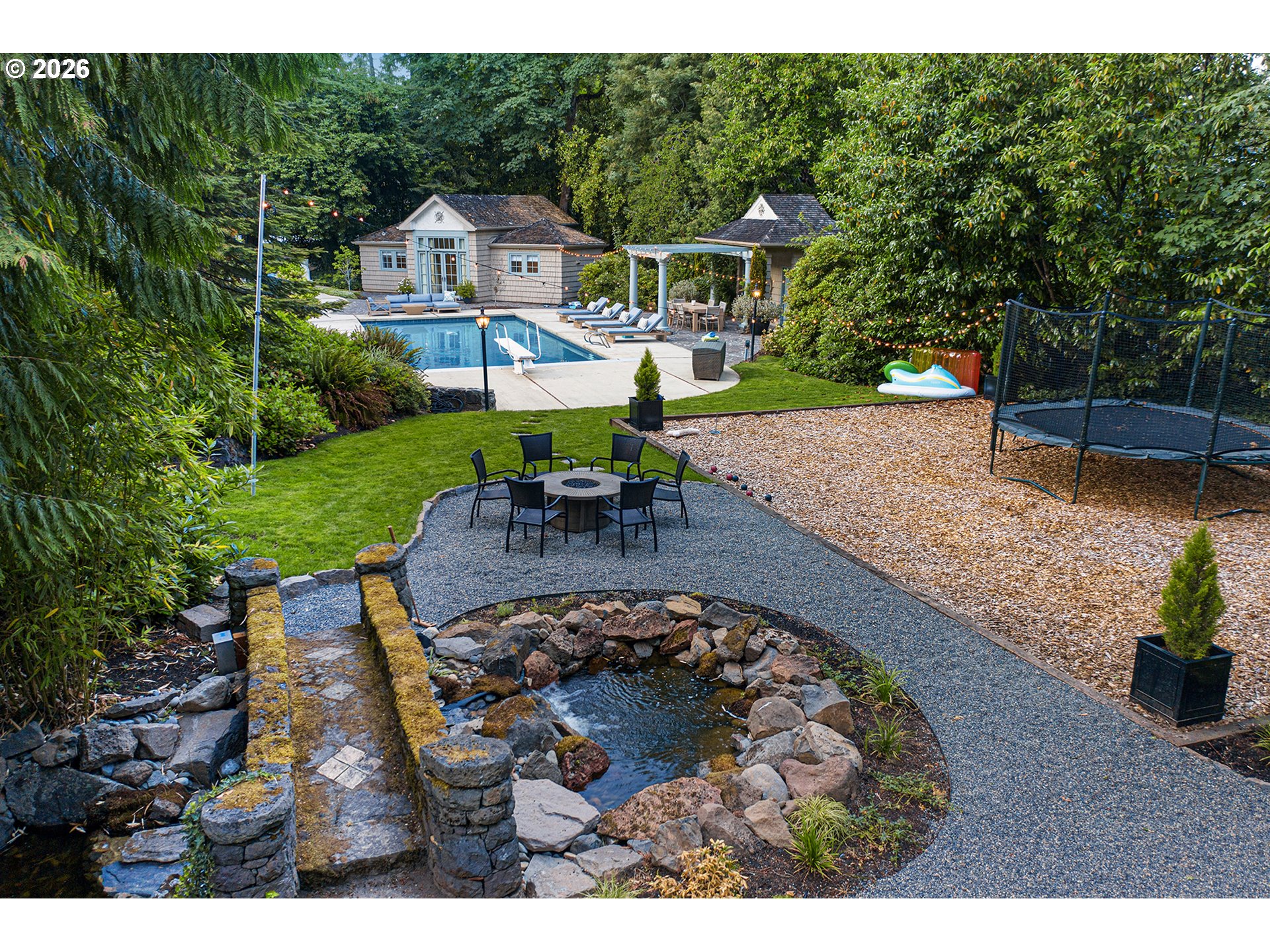 1905 South Greenwood Road Portland, OR 97219 - Photo 41 of 46 a view of a house with a yard patio and fire pit