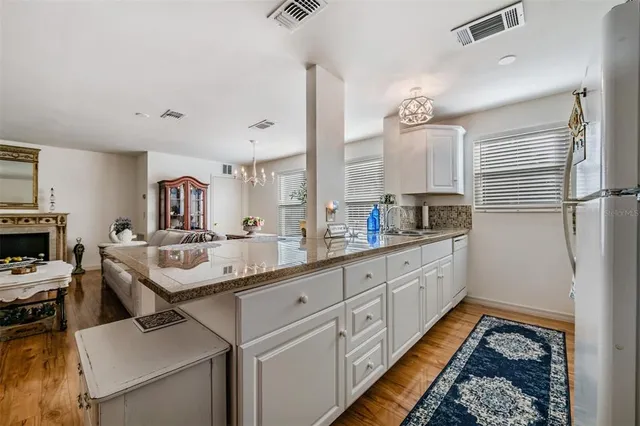 a kitchen with a sink and refrigerator