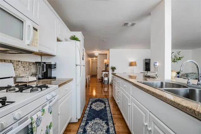 a kitchen with sink and cabinets
