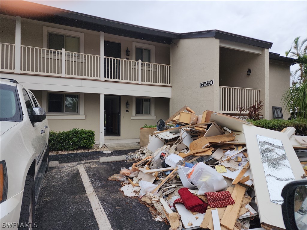 16560 Partridge Place Road, Unit 103 Fort Myers, FL 33908 - Photo 1 of 4 a front view of a house with patio
