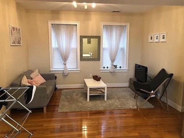 61 Wait Street, Unit 3 Boston, MA 02120 - Photo 1 of 10 a living room with furniture and a wooden floor