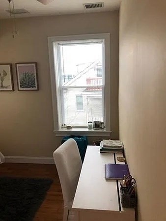 61 Wait Street, Unit 3 Boston, MA 02120 - Photo 5 of 10 a room with wooden floor and windows