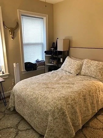 61 Wait Street, Unit 3 Boston, MA 02120 - Photo 6 of 10 a bedroom with a bed and wooden floor