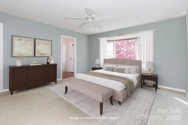 a spacious bedroom with a bed and a dresser
