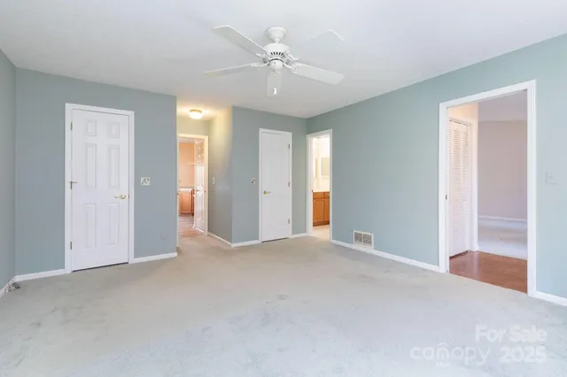 a view of an empty room with a ceiling fan