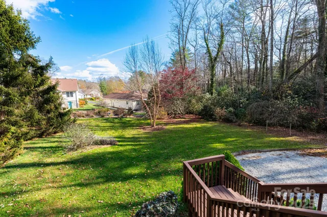 a two chairs sitting in a yard with swimming pool