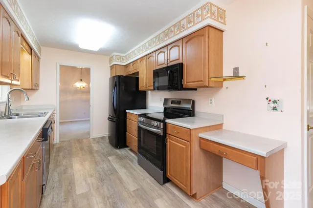 a kitchen with stainless steel appliances a stove microwave and sink