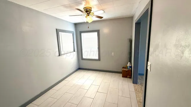 a view of an empty room with a window