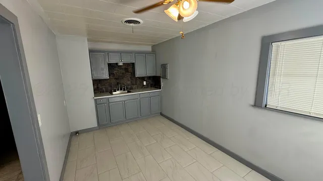 a kitchen with stainless steel appliances a sink stove and cabinets