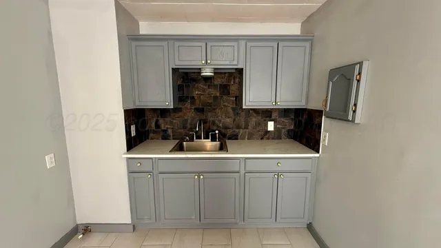 a kitchen with a sink and cabinets