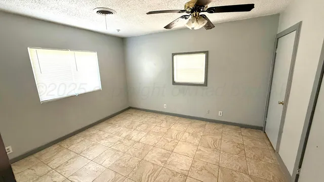 a view of an empty room with a window